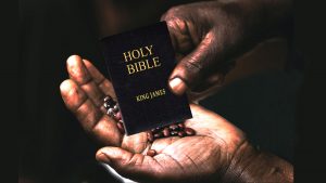 Man with seeds in hand and miniature King James Bible