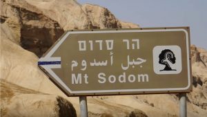 Sign in Israel along Dead Sea pointing to Mt. Sodom