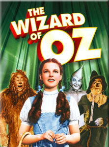 The Wizard of Oz with characters from play in background